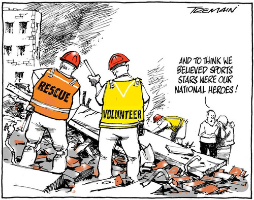 Several volunteers work amongst the ruins of a building. A woman nearby weeps and the man comforting her comments 'and to think we believed sports stars were our national heroes'.