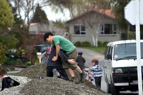 Children playing on a pile of gravel in a residential area following the September earthquake.